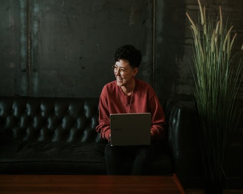 Person taking a short break looking away from the laptop screen